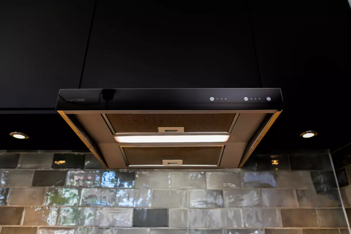 CASA R2 ventilation unit and Jazz cooker hood installed in black kitchen. Kitchen cabin door as front panel.